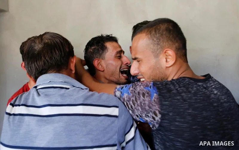 Relatives of Palestinian Ahemd Omar who was shot dead by Israeli troops during a demonstration against Israeli blockade on Gaza Strip, at the Erez crossing with Israel mourn during his funeral at el-Shati refugee camp in...