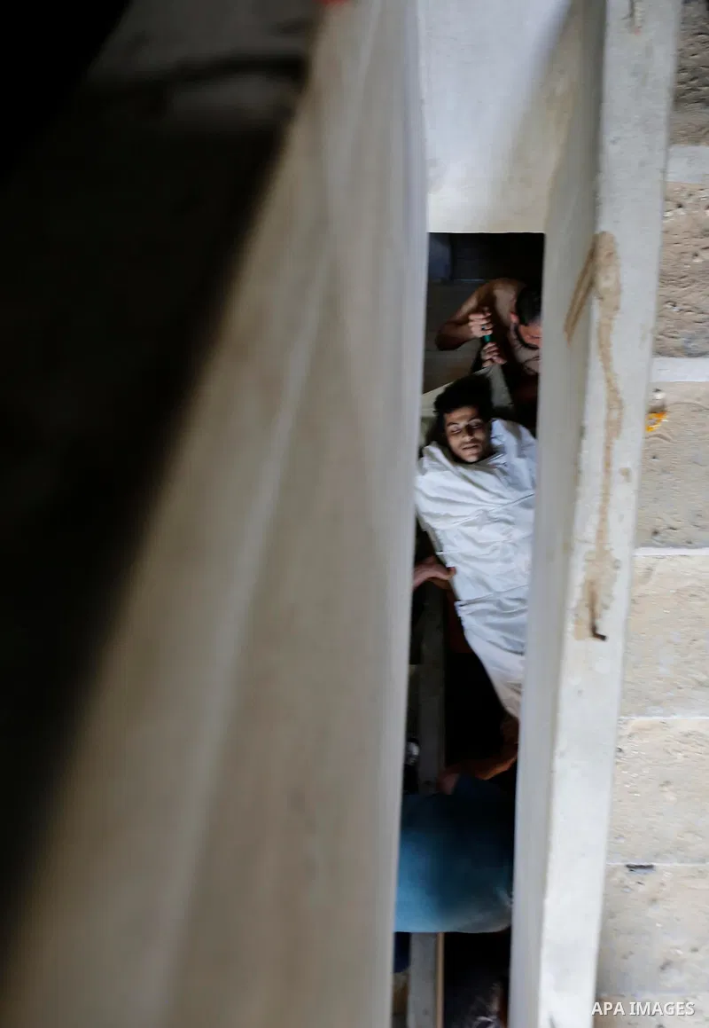Mourners carry the body of Palestinian Ahemd Omar who was shot dead by Israeli troops during a demonstration against Israeli blockade on Gaza Strip, at the Erez crossing with Israel during his funeral at el-Shati refugee...