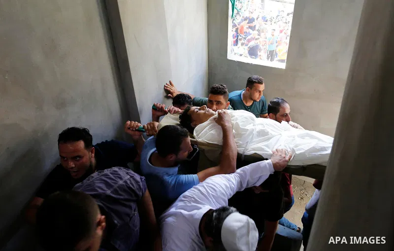 Mourners carry the body of Palestinian Ahemd Omar who was shot dead by Israeli troops during a demonstration against Israeli blockade on Gaza Strip, at the Erez crossing with Israel during his funeral at el-Shati refugee...
