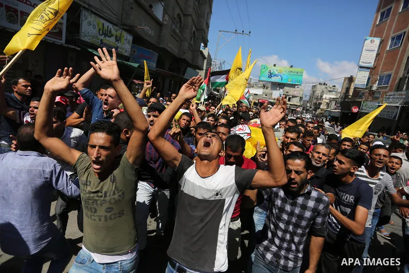 Mourners carry the bodies of Palestinian Alaa Abu Assi and Naji Abu Assi who were killed in an Israeli air strike at the Israel-Gaza border during their funeral in Khan Younis in the southern Gaza Strip on September 19,...