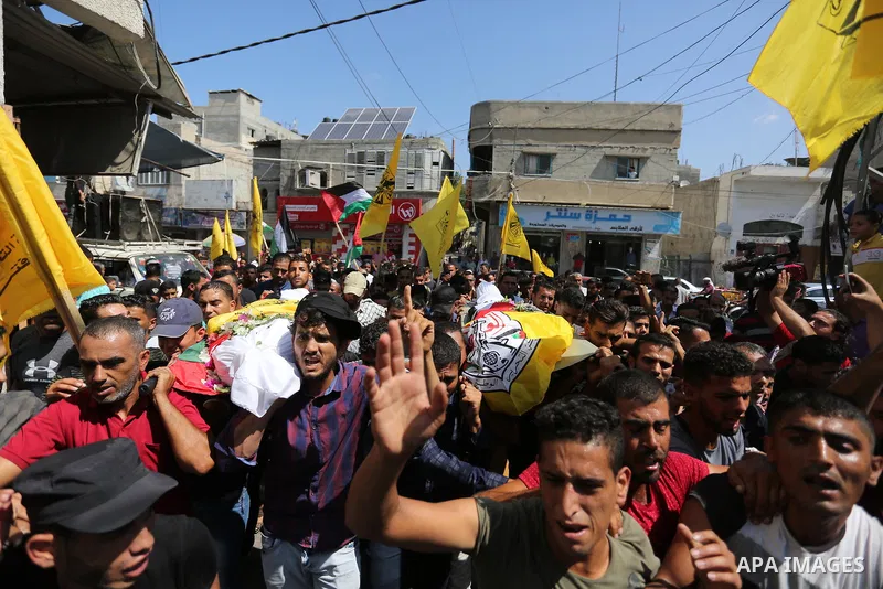 Mourners carry the bodies of Palestinian Alaa Abu Assi and Naji Abu Assi who were killed in an Israeli air strike at the Israel-Gaza border during their funeral in Khan Younis in the southern Gaza Strip on September 19,...