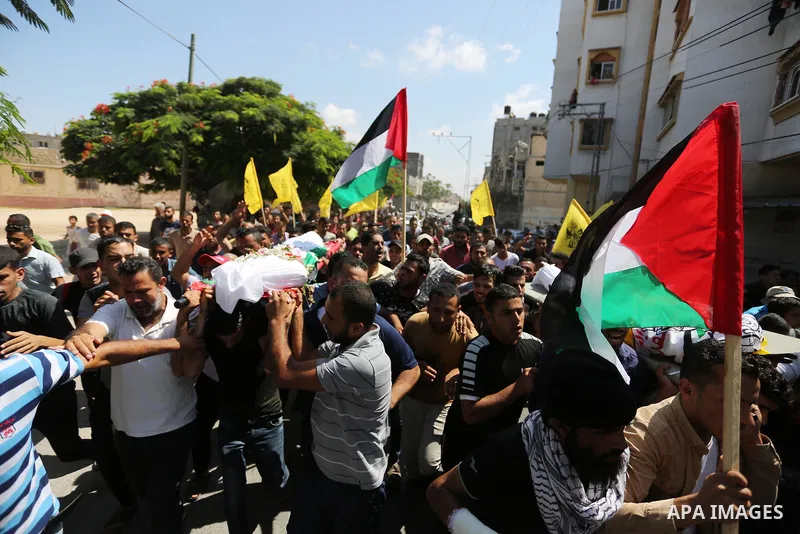 Mourners carry the bodies of Palestinian Alaa Abu Assi and Naji Abu Assi who were killed in an Israeli air strike at the Israel-Gaza border during their funeral in Khan Younis in the southern Gaza Strip on September 19,...
