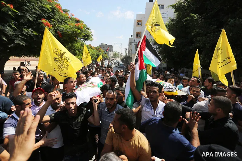 Mourners carry the bodies of Palestinian Alaa Abu Assi and Naji Abu Assi who were killed in an Israeli air strike at the Israel-Gaza border during their funeral in Khan Younis in the southern Gaza Strip on September 19,...