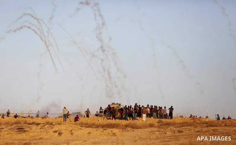 Palestinian protesters gather during clashes with Israeli forces in tents protest where Palestinians demand the right to return to their homeland at the Israel-Gaza border, in Deir al-Balah in the center of Gaza Strip on...