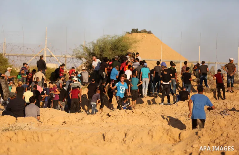 Palestinian protesters gather during clashes with Israeli forces in tents protest where Palestinians demand the right to return to their homeland at the Israel-Gaza border, in Deir al-Balah in the center of Gaza Strip on...