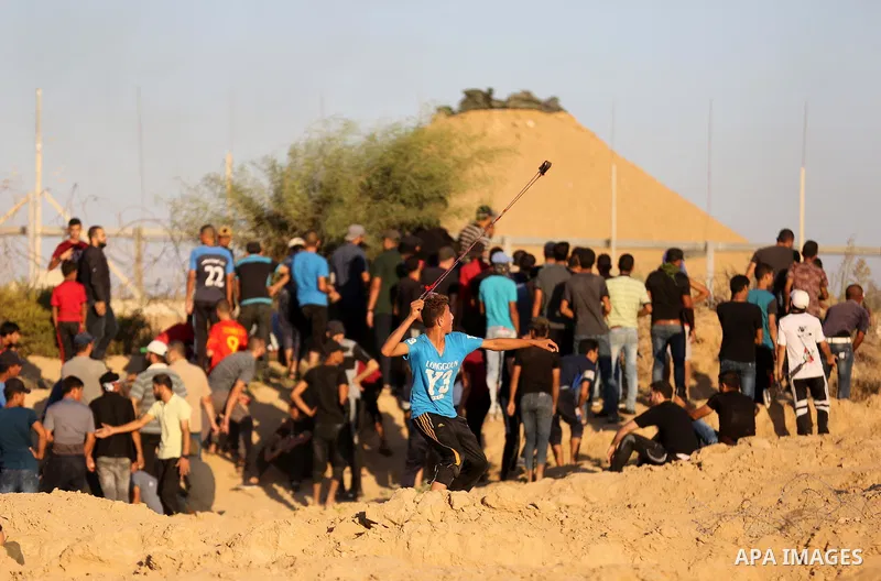 Palestinian protesters gather during clashes with Israeli forces in tents protest where Palestinians demand the right to return to their homeland at the Israel-Gaza border, in Deir al-Balah in the center of Gaza Strip on...