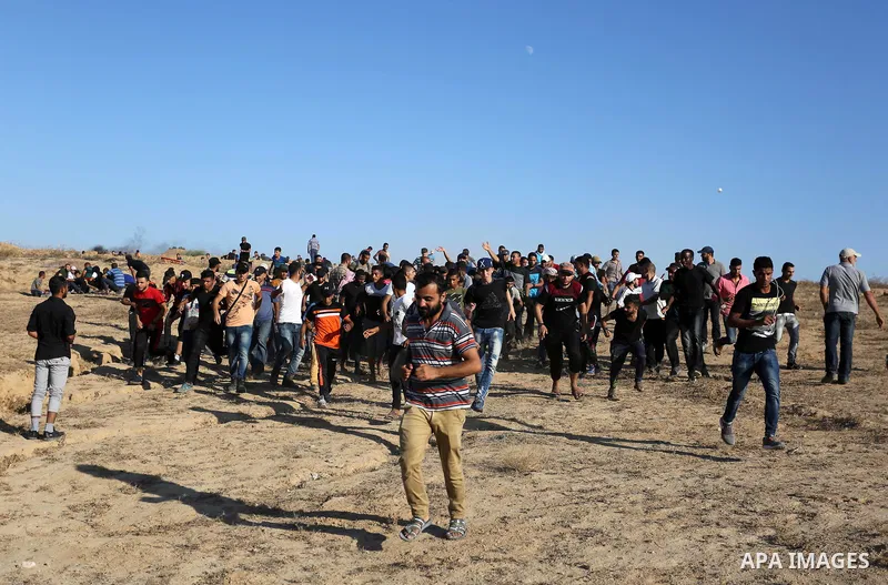Palestinian protesters gather during clashes with Israeli forces in tents protest where Palestinians demand the right to return to their homeland at the Israel-Gaza border, in Deir al-Balah in the center of Gaza Strip on...