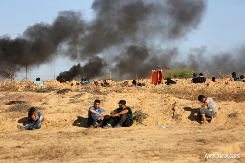 Palestinian protesters gather during clashes with Israeli forces in tents protest where Palestinians demand the right to return to their homeland at the Israel-Gaza border, in Deir al-Balah in the center of Gaza Strip on...