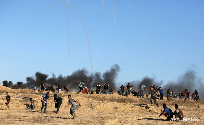 Palestinian protesters gather during clashes with Israeli forces in tents protest where Palestinians demand the right to return to their homeland at the Israel-Gaza border, in Deir al-Balah in the center of Gaza Strip on...