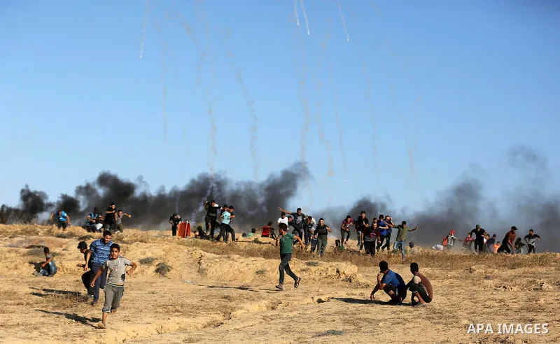 Palestinian protesters gather during clashes with Israeli forces in tents protest where Palestinians demand the right to return to their homeland at the Israel-Gaza border, in Deir al-Balah in the center of Gaza Strip on...