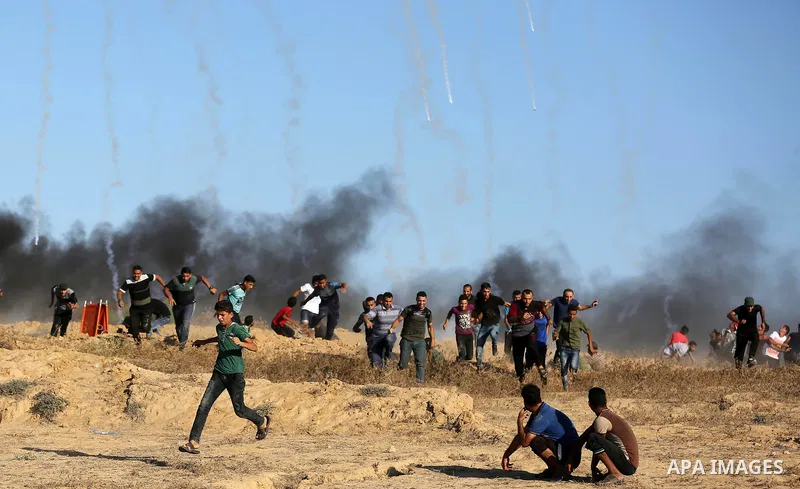 Palestinian protesters gather during clashes with Israeli forces in tents protest where Palestinians demand the right to return to their homeland at the Israel-Gaza border, in Deir al-Balah in the center of Gaza Strip on...
