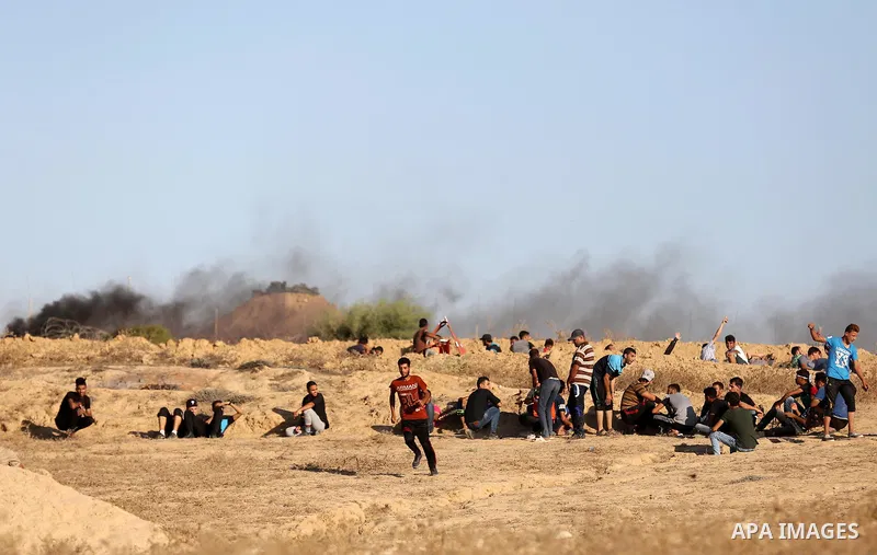 Palestinian protesters gather during clashes with Israeli forces in tents protest where Palestinians demand the right to return to their homeland at the Israel-Gaza border, in Deir al-Balah in the center of Gaza Strip on...