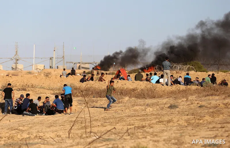 Palestinian protesters gather during clashes with Israeli forces in tents protest where Palestinians demand the right to return to their homeland at the Israel-Gaza border, in Deir al-Balah in the center of Gaza Strip on...