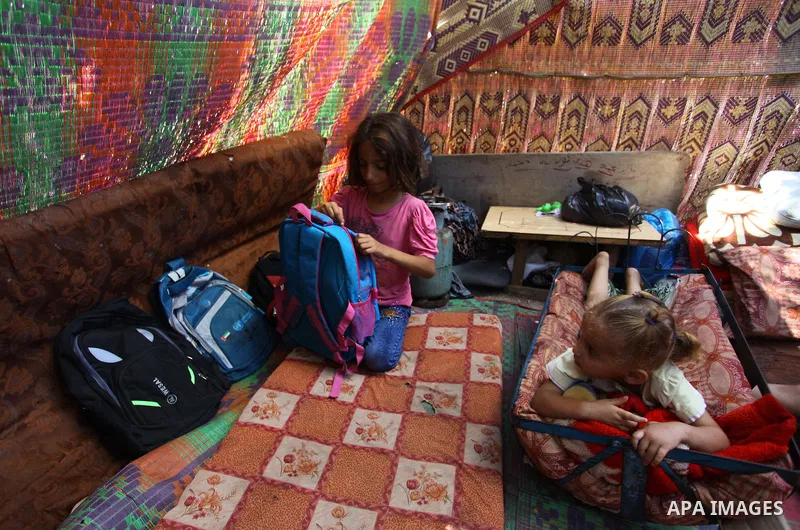 Palestinian Waleed Abu Shawish and his family sit inside their tent as he can't pay rent of house, in the middle of Gaza City, on September 20, 2018. Photo by Mahmoud Ajour