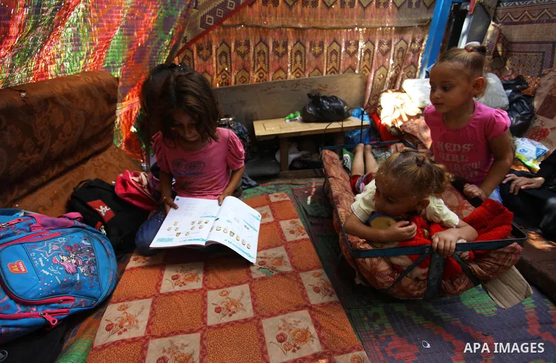 Palestinian Waleed Abu Shawish and his family sit inside their tent as he can't pay rent of house, in the middle of Gaza City, on September 20, 2018. Photo by Mahmoud Ajour