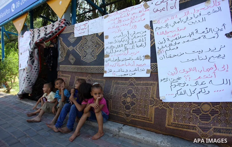 Palestinian Waleed Abu Shawish and his family sit outside their tent as he can't pay rent of house, in the middle of Gaza City, on September 20, 2018. Photo by Mahmoud Ajour