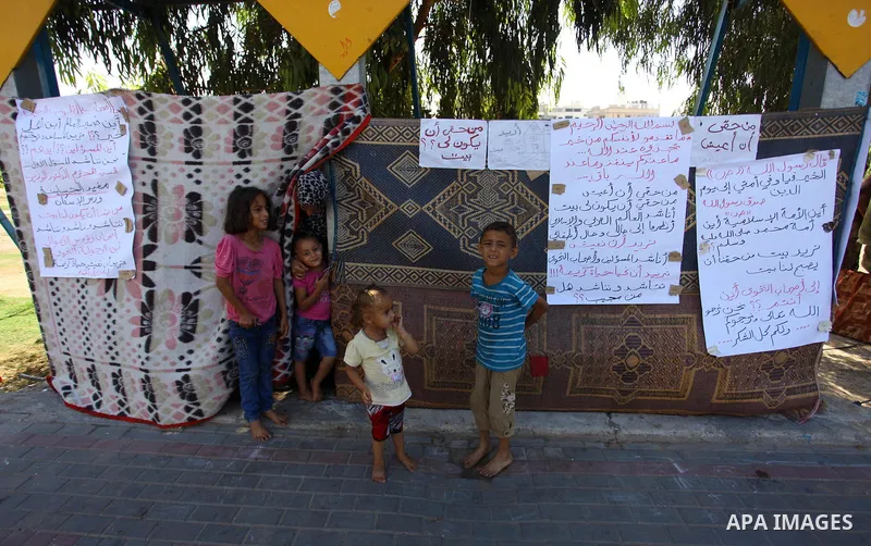 Palestinian Waleed Abu Shawish and his family sit outside their tent as he can't pay rent of house, in the middle of Gaza City, on September 20, 2018. Photo by Mahmoud Ajour