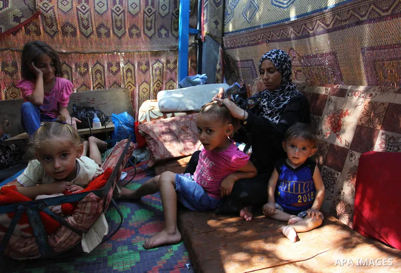 Palestinian Waleed Abu Shawish and his family sit inside their tent as he can't pay rent of house, in the middle of Gaza City, on September 20, 2018. Photo by Mahmoud Ajour