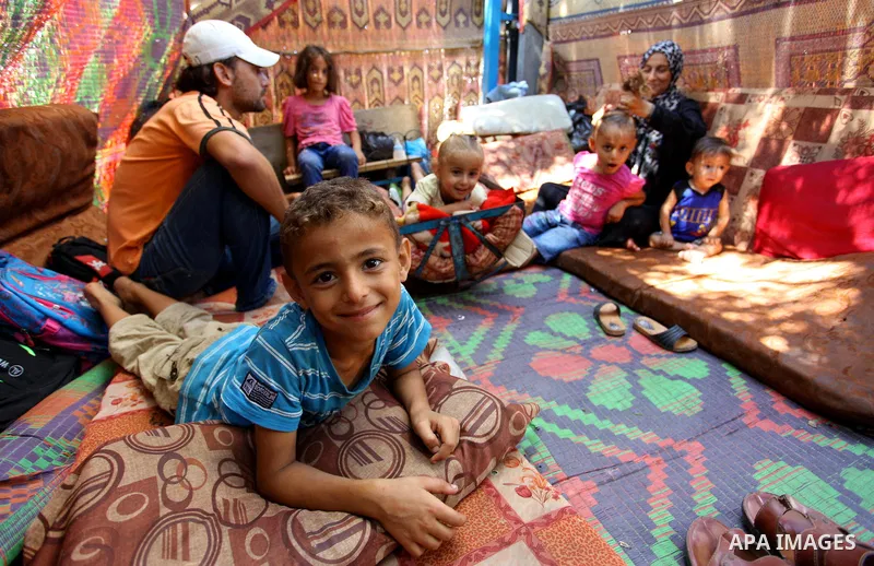 Palestinian Waleed Abu Shawish and his family sit inside their tent as he can't pay rent of house, in the middle of Gaza City, on September 20, 2018. Photo by Mahmoud Ajour