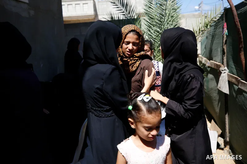 Mourners carry the body of Palestinian Mo'men Abu Eyada 15, who was shot dead by Israeli troops during clashes in tents protest at the Israel-Gaza border, during his funeral in Rafah in the southern Gaza Strip on Septemb...