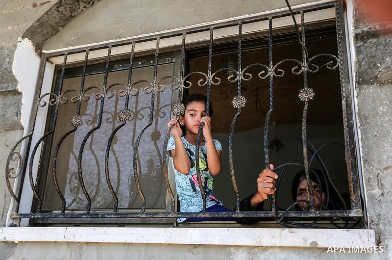 Relatives of Palestinian Mo'men Abu Eyada 15, who was shot dead by Israeli troops during clashes in tents protest at the Israel-Gaza border, mourn during his funeral in Rafah in the southern Gaza Strip on September 20, 2...