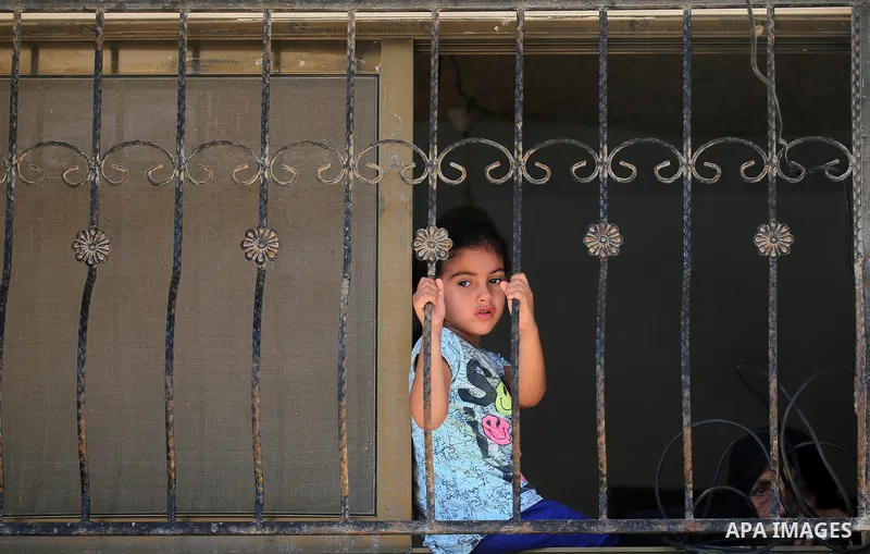 Relatives of Palestinian Mo'men Abu Eyada 15, who was shot dead by Israeli troops during clashes in tents protest at the Israel-Gaza border, mourn during his funeral in Rafah in the southern Gaza Strip on September 20, 2...