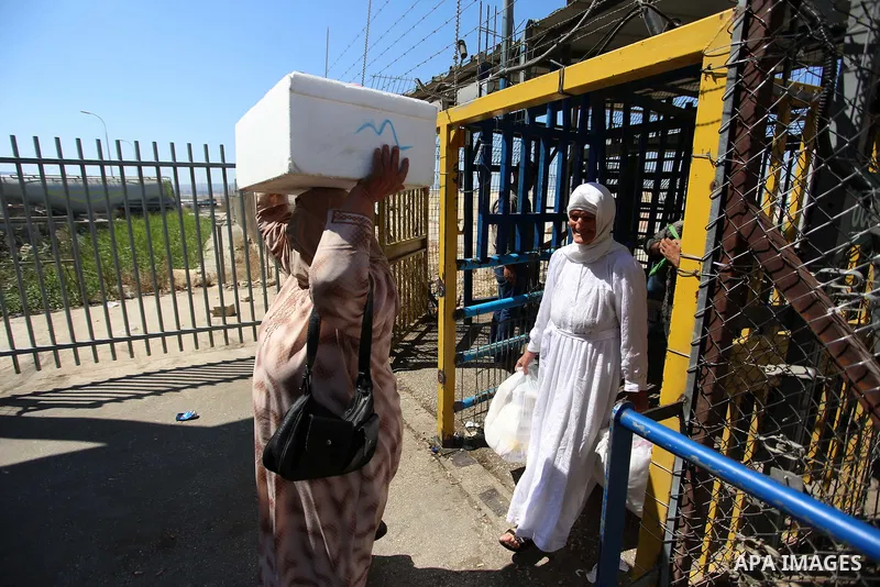 Palestinians make their way through Israeli checkpoint in the West Bank city of Jenin during Jewish holidays on September 20, 2018. Photo by Shadi Jarar'ah