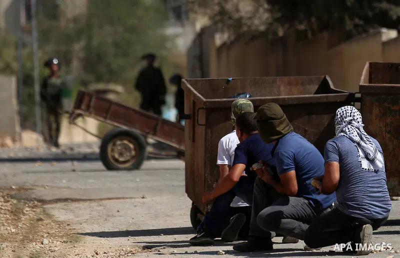 Palestinian protesters hurl stones towards Israeli forces during clashes following a weekly demonstration against the expropriation of Palestinian land by Israel in the village of Kfar Qaddum, near the West Bank city of...