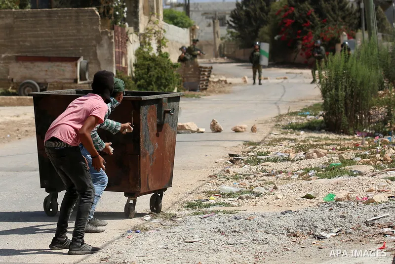 Palestinian protesters hurl stones towards Israeli forces during clashes following a weekly demonstration against the expropriation of Palestinian land by Israel in the village of Kfar Qaddum, near the West Bank city of...