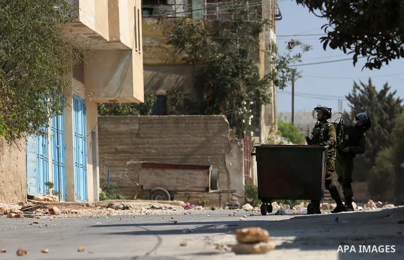 Israeli forces take position during clashes with Palestinian protesters following a weekly demonstration against the expropriation of Palestinian land by Israel in the village of Kfar Qaddum, near the West Bank city of N...