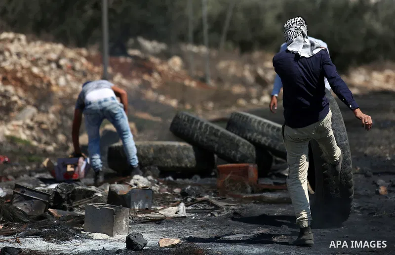 Palestinian protesters burn tires during clashes with Israeli forces following a weekly demonstration against the expropriation of Palestinian land by Israel in the village of Kfar Qaddum, near the West Bank city of Nabl...