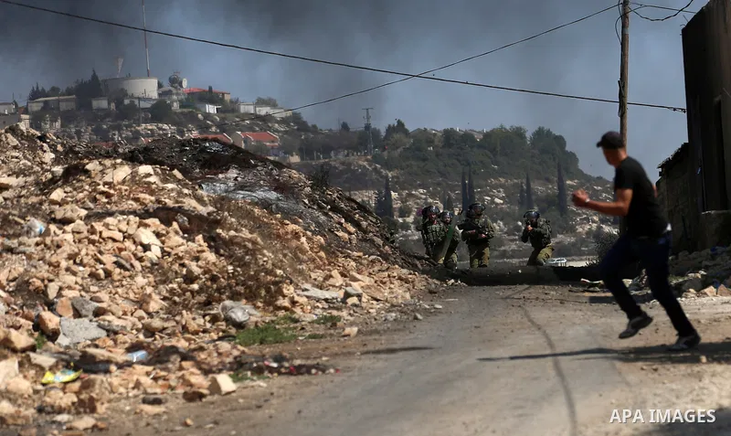 Israeli forces take position during clashes with Palestinian protesters following a weekly demonstration against the expropriation of Palestinian land by Israel in the village of Kfar Qaddum, near the West Bank city of N...