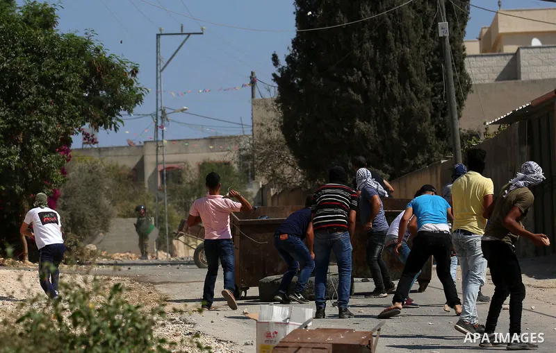 Palestinian protesters hurl stones towards Israeli forces during clashes following a weekly demonstration against the expropriation of Palestinian land by Israel in the village of Kfar Qaddum, near the West Bank city of...