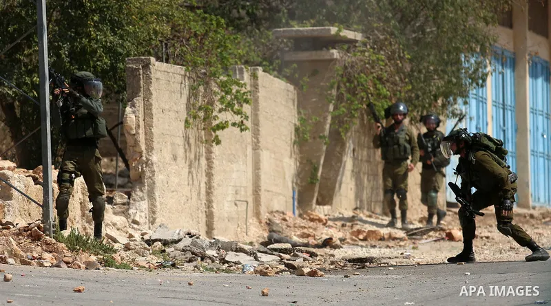 Israeli forces take position during clashes with Palestinian protesters following a weekly demonstration against the expropriation of Palestinian land by Israel in the village of Kfar Qaddum, near the West Bank city of N...