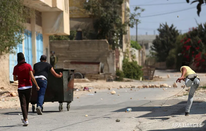 Palestinian protesters hurl stones towards Israeli forces during clashes following a weekly demonstration against the expropriation of Palestinian land by Israel in the village of Kfar Qaddum, near the West Bank city of...