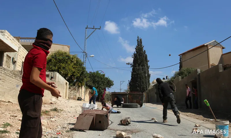 Palestinian protesters hurl stones towards Israeli forces during clashes following a weekly demonstration against the expropriation of Palestinian land by Israel in the village of Kfar Qaddum, near the West Bank city of...