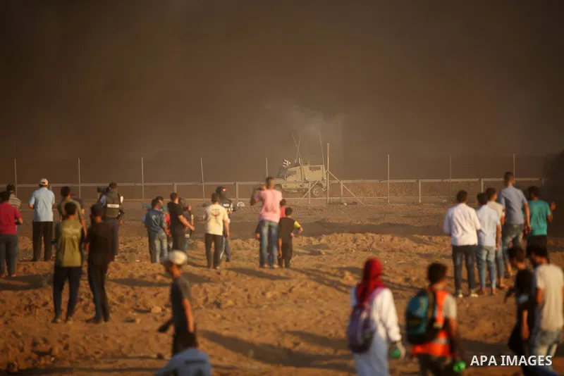 Palestinian protesters gather during clashes with Israeli troops in tents protest where Palestinians demand the right to return to their homeland at the Israel-Gaza border, in east of Gaza City on September 21, 2018. Pho...