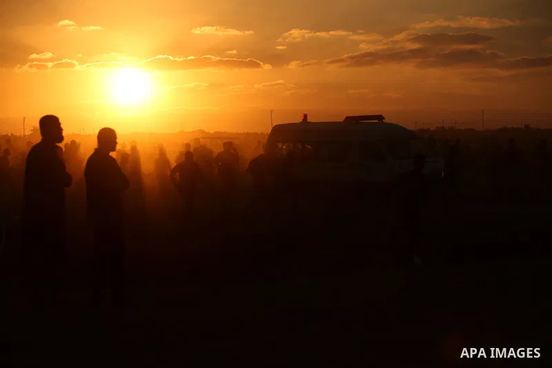 Palestinian protesters gather during clashes with Israeli troops in tents protest where Palestinians demand the right to return to their homeland at the Israel-Gaza border, in east of Gaza City on September 21, 2018. Pho...
