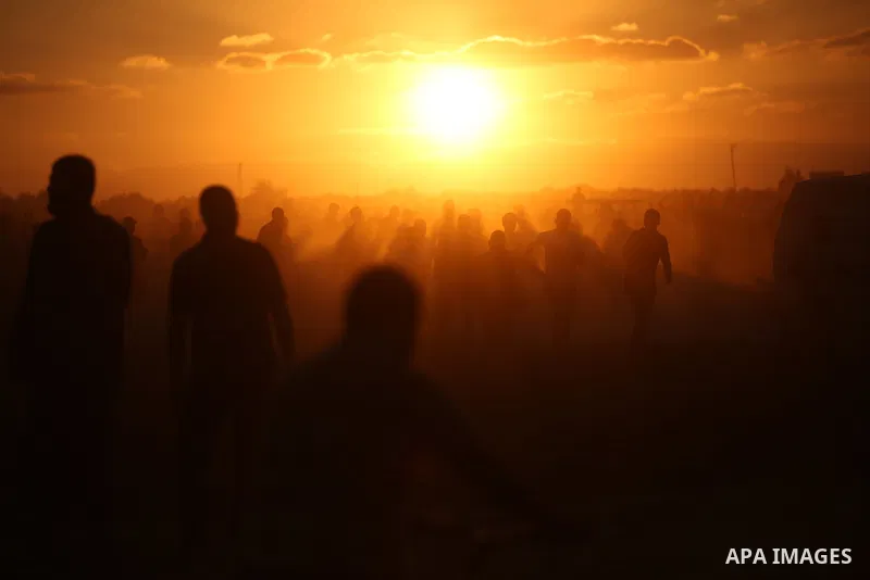 Palestinian protesters gather during clashes with Israeli troops in tents protest where Palestinians demand the right to return to their homeland at the Israel-Gaza border, in east of Gaza City on September 21, 2018. Pho...