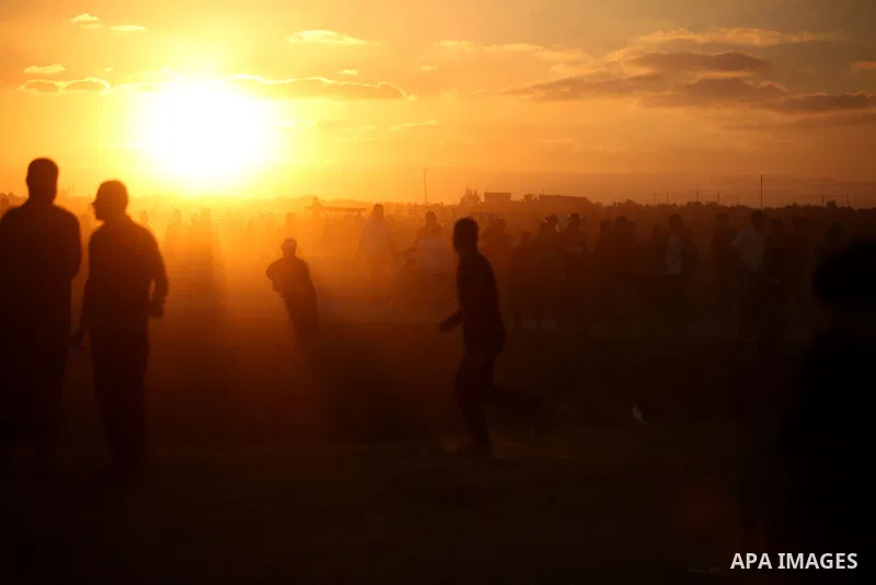 Palestinian protesters gather during clashes with Israeli troops in tents protest where Palestinians demand the right to return to their homeland at the Israel-Gaza border, in east of Gaza City on September 21, 2018. Pho...