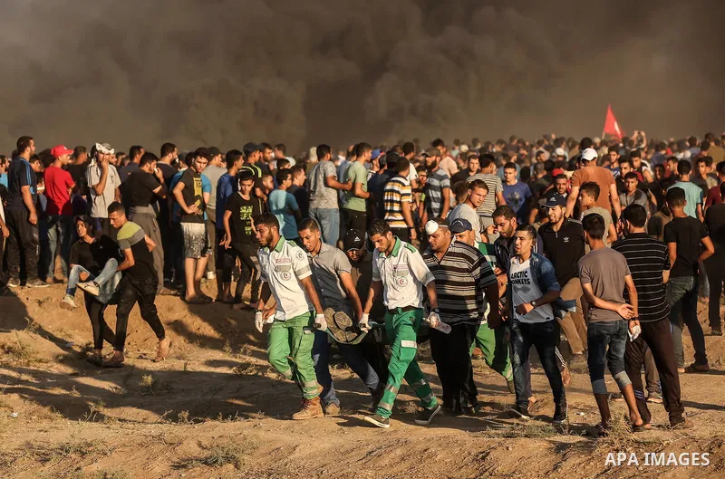 Palestinian protesters gather during clashes with Israeli troops in tents protest where Palestinians demand the right to return to their homeland at the Israel-Gaza border, in east of Gaza City on September 21, 2018. Pho...