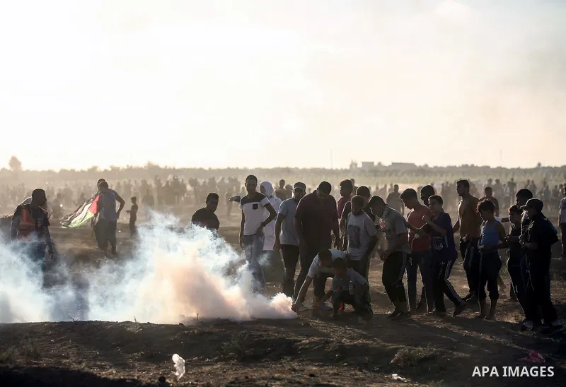 Palestinian protesters gather during clashes with Israeli troops in tents protest where Palestinians demand the right to return to their homeland at the Israel-Gaza border, in east of Gaza City on September 21, 2018. Pho...