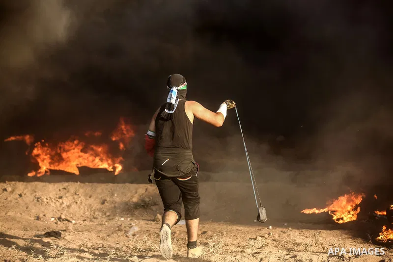 Palestinian protesters gather during clashes with Israeli troops in tents protest where Palestinians demand the right to return to their homeland at the Israel-Gaza border, in east of Gaza City on September 21, 2018. Pho...
