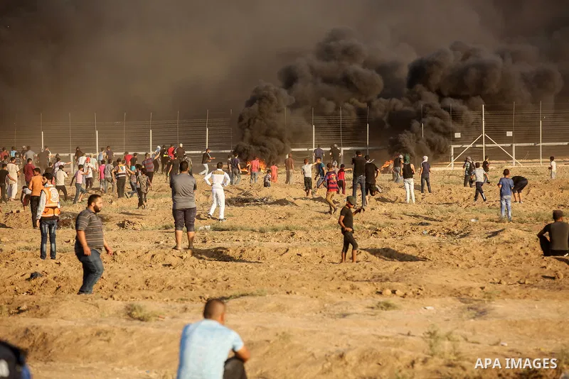 Palestinian protesters gather during clashes with Israeli troops in tents protest where Palestinians demand the right to return to their homeland at the Israel-Gaza border, in east of Gaza City on September 21, 2018. Pho...