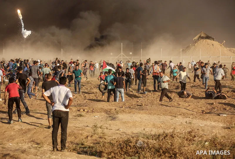Palestinian protesters gather during clashes with Israeli troops in tents protest where Palestinians demand the right to return to their homeland at the Israel-Gaza border, in east of Gaza City on September 21, 2018. Pho...