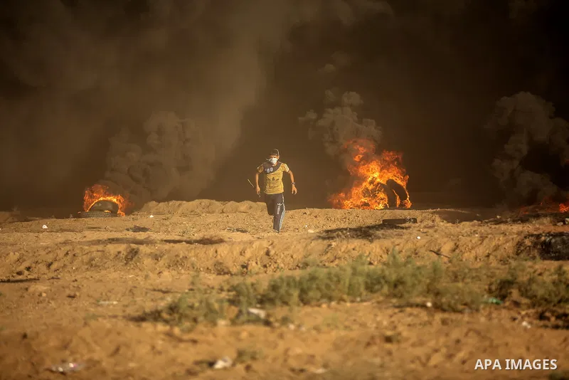 Palestinian protesters gather during clashes with Israeli troops in tents protest where Palestinians demand the right to return to their homeland at the Israel-Gaza border, in east of Gaza City on September 21, 2018. Pho...