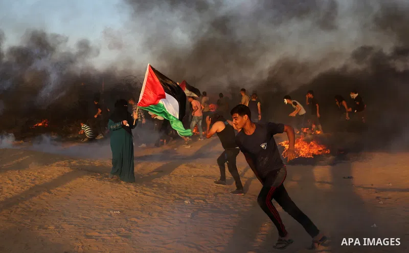 Palestinian protesters gather during clashes with Israeli troops in tents protest where Palestinians demand the right to return to their homeland at the Israel-Gaza border, in Khan Younis in the southern of Gaza Strip on...