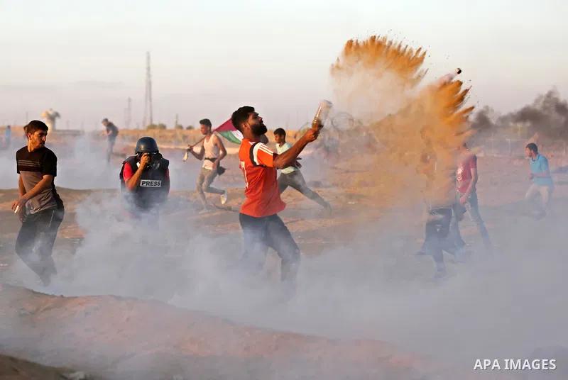 Palestinian protesters gather during clashes with Israeli troops in tents protest where Palestinians demand the right to return to their homeland at the Israel-Gaza border, in Khan Younis in the southern of Gaza Strip on...