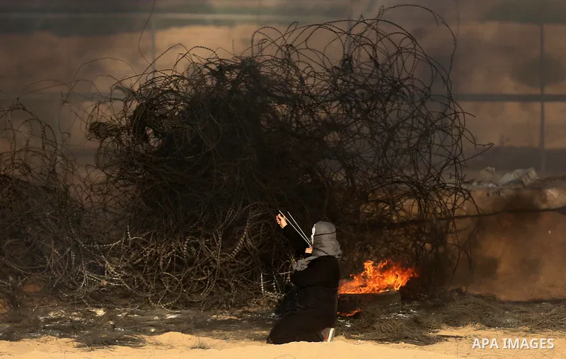 Palestinian protesters gather during clashes with Israeli troops in tents protest where Palestinians demand the right to return to their homeland at the Israel-Gaza border, in Khan Younis in the southern of Gaza Strip on...