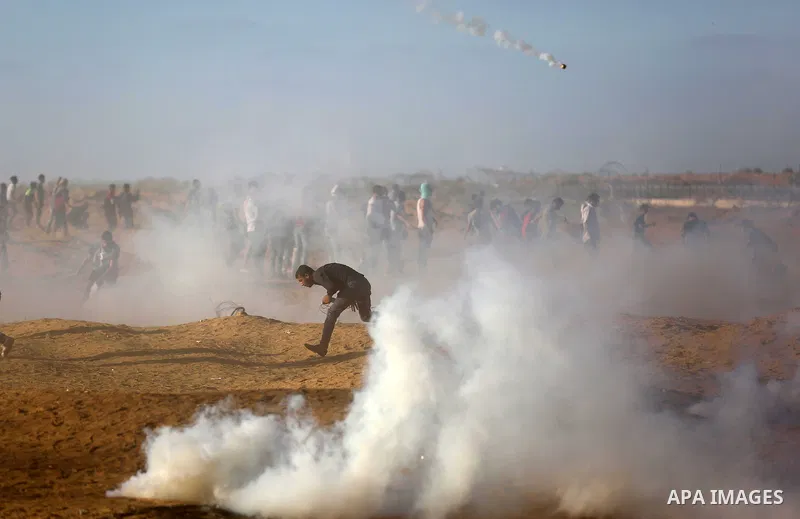 Palestinian protesters gather during clashes with Israeli troops in tents protest where Palestinians demand the right to return to their homeland at the Israel-Gaza border, in Khan Younis in the southern of Gaza Strip on...